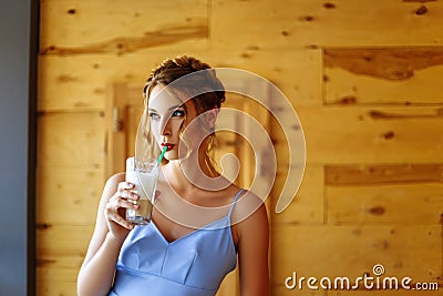 Portrait of a beautiful girl in a cofee with a glass of cappuccino Stock Photo