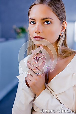 Portrait of a beautiful girl with diamonds in a jewelry salon. The girl& x27;s face has a flawless shine, and the model Stock Photo