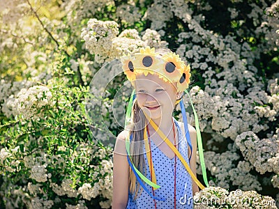 Portrait of beautiful girl with flowers of sunflowers on his head. Stock Photo