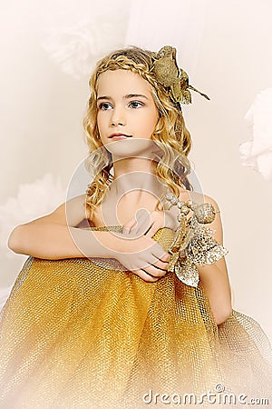 Portrait of a beautiful girl in a gold Stock Photo