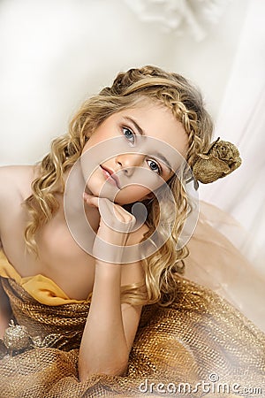 Portrait of a beautiful girl in a gold Stock Photo