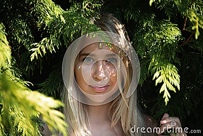 Portrait of a beautiful girl in green leaves Stock Photo