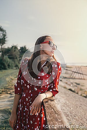 Portrait of a beautiful girl in a red dress and goggles on vacation Stock Photo