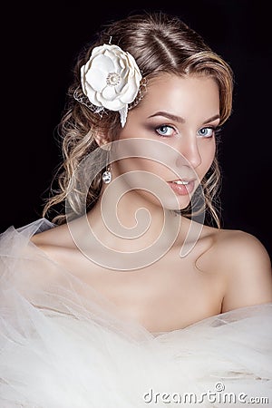 Portrait of beautiful happy gentle women bride in a white wedding dress c beautiful salon wedding hair with white flowers in her Stock Photo