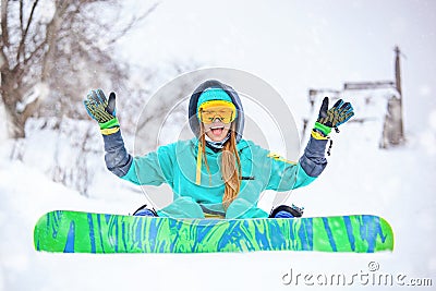 Beautiful happy young snowboarder girl with snowboard. Stock Photo