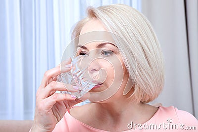 Portrait beautiful middle aged woman drinking water in the morning Stock Photo