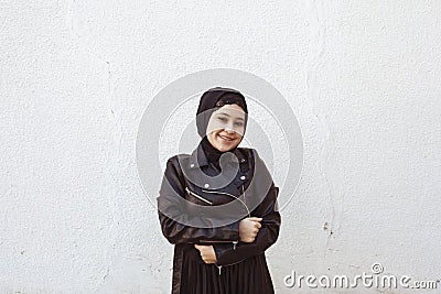 Portrait of beautiful middle-eastern girl in traditional Islamic clothing - hijab. Modern and young Iranian woman in leather Stock Photo