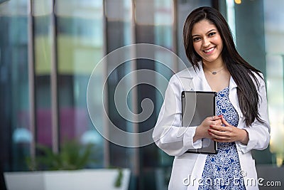 Portrait of a beautiful mixed ethnicity Hispanic Indian woman, medical professional, student, intern, or assistant at the workplac Stock Photo