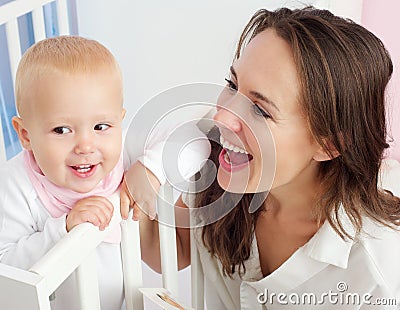 Portrait of a beautiful mother with cute baby smiling Stock Photo