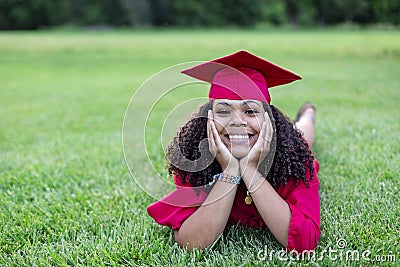 Portrait of a beautiful multiethnic woman in her graduation cap and gown Stock Photo