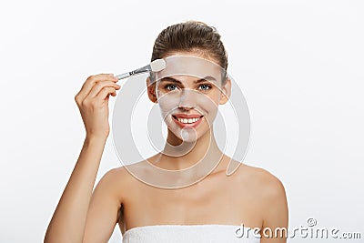 Portrait beautiful naked woman apply cosmetic white clay mask on with brush. Isolated on a white background. concept of Stock Photo