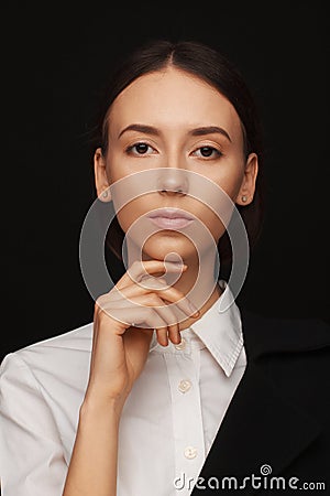 Portrait of a beautiful pacified woman in a white shirt and black jacket. Studio photo session Stock Photo