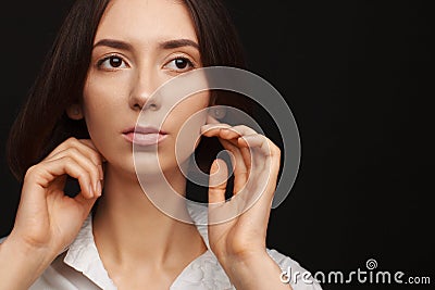 Portrait of a beautiful pacified woman in a white shirt on a light background Stock Photo