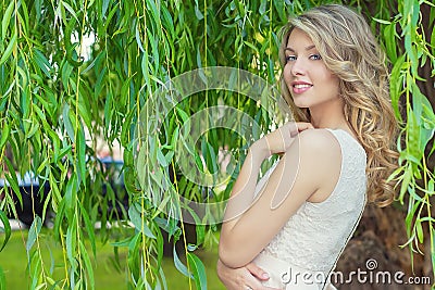 Portrait of beautiful happy smiling girl with big full lips, with white hair in a white dress Stock Photo