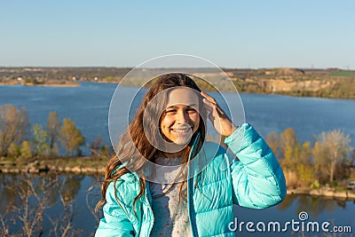 Portrait of a beautiful smiling teen girl on a lake background Stock Photo