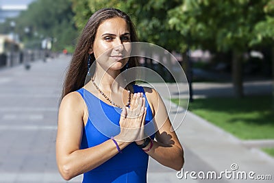 Portrait of beautiful smiling young woman enjoying yoga, relaxing, feeling alive, breathing fresh air Stock Photo