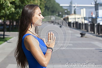 Portrait of beautiful smiling young woman enjoying yoga, relaxing, feeling alive, breathing fresh air Stock Photo