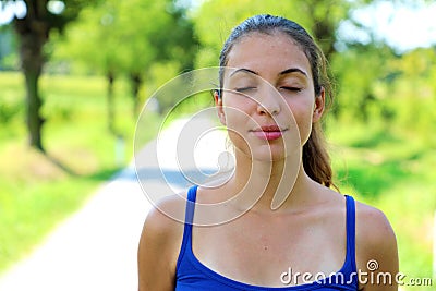 Portrait of beautiful smiling young woman enjoying yoga, relaxing, feeling alive, breathing fresh air, got freedom from work Stock Photo