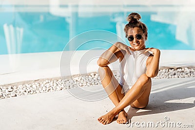 Portrait of beautiful tanned sporty slim woman relaxing in swimming pool spa. Stock Photo