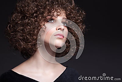 Portrait of a beautiful teen girl with natural make-up and afro curls Stock Photo