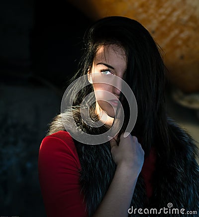 Portrait of beautiful vampire young woman with glowing eyes Stock Photo