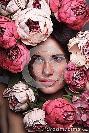 Portrait of beautiful woman with flowers around her face Stock Photo