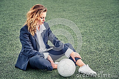 Portrait of a beautiful woman football player in a strict office suit, concept sports office manager leisure Stock Photo