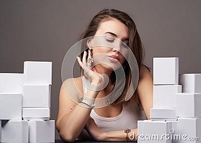 Portrait of beautiful woman with a gifts on grey background with copy space Stock Photo