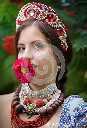 Ethnic russian national costume woman with a flower at ÑŒÑ‰Ð³ÐµÑ€ Stock Photo