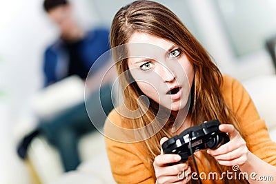 Portrait of beautiful woman playing videogame at home Stock Photo