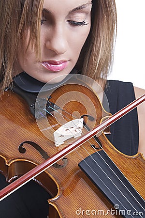 Portrait of a beautiful woman playing violin. Stock Photo