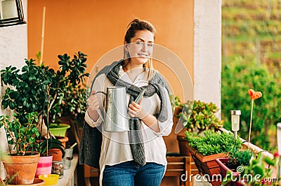 Portrait of beautiful woman watering green plants Stock Photo