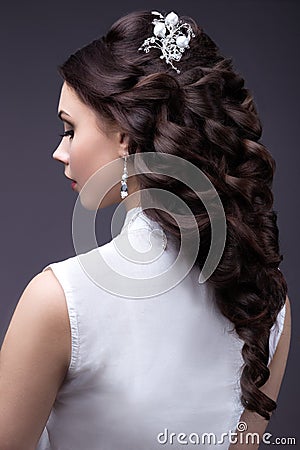 Portrait of a beautiful woman in a wedding dress in the image of the bride. Hairstyle back view Stock Photo