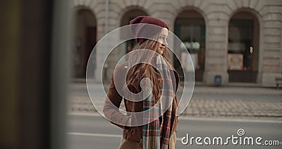 Portrait of beautiful youn woman standing in a city street. Stock Photo