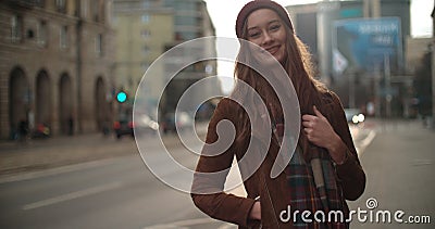 Portrait of beautiful youn woman standing in a city street. Stock Photo