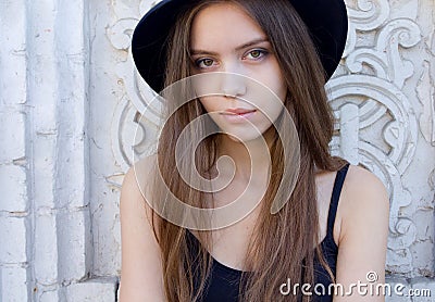 Portrait of a beautiful young adult girl in black hat outdoor Stock Photo