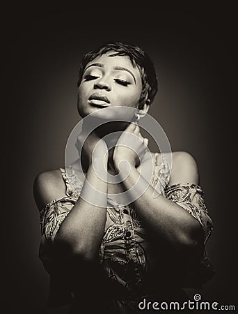 Portrait of a beautiful young African woman over yellow background. Studio picture Stock Photo