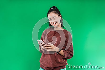 Portrait beautiful young Asian girl smiling cute holding a phone while looking at the camera Stock Photo