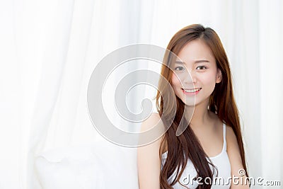 Portrait beautiful young asian woman standing and smile the window at bedroom Stock Photo