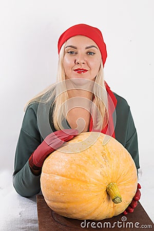 Portrait of beautiful young blonde woman with pumpkin ready for halloween celebration, mockup for postcard and invitation or adver Stock Photo