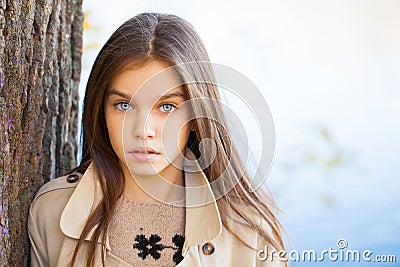 Portrait of a beautiful brunette little girl, autumn park outdoors Stock Photo