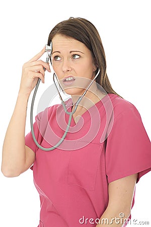 Portrait Of A Beautiful Young Curious Female Doctor Acting Silly with Stethoscope Stock Photo