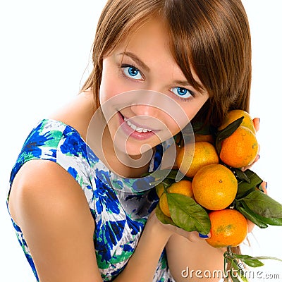 Portrait of a beautiful young girl with tangerines. Stock Photo