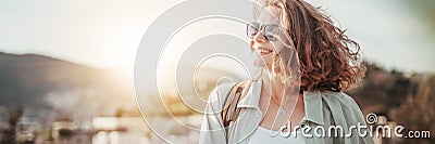 Portrait of a beautiful young smiling curly woman in the sun outdoor, panormama banner format Stock Photo