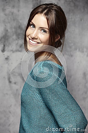 Portrait of a beautiful young woman, against cement wall Stock Photo