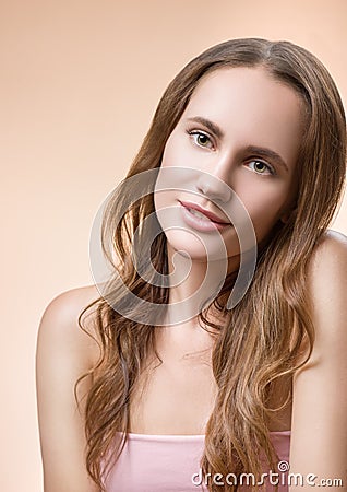 Portrait of a beautiful young woman on a beige background Stock Photo