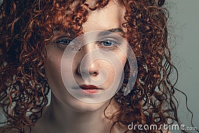 Portrait of beautiful young woman with curly hair, close up view Stock Photo