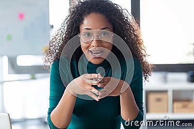 Beautiful young woman explaing something looking at camera in the office Stock Photo