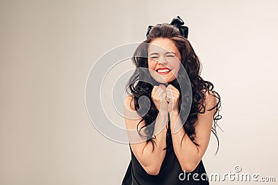 Portrait of beautiful young woman on grey studio background Stock Photo