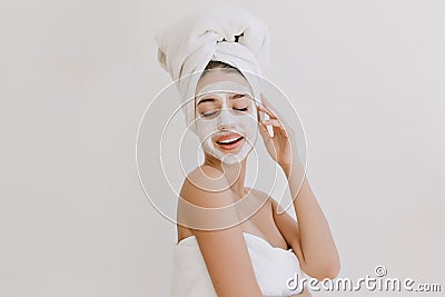 Portrait of beautiful young woman having fun with towels after take bath make cosmetic mask on her face. Rejuvenation Stock Photo